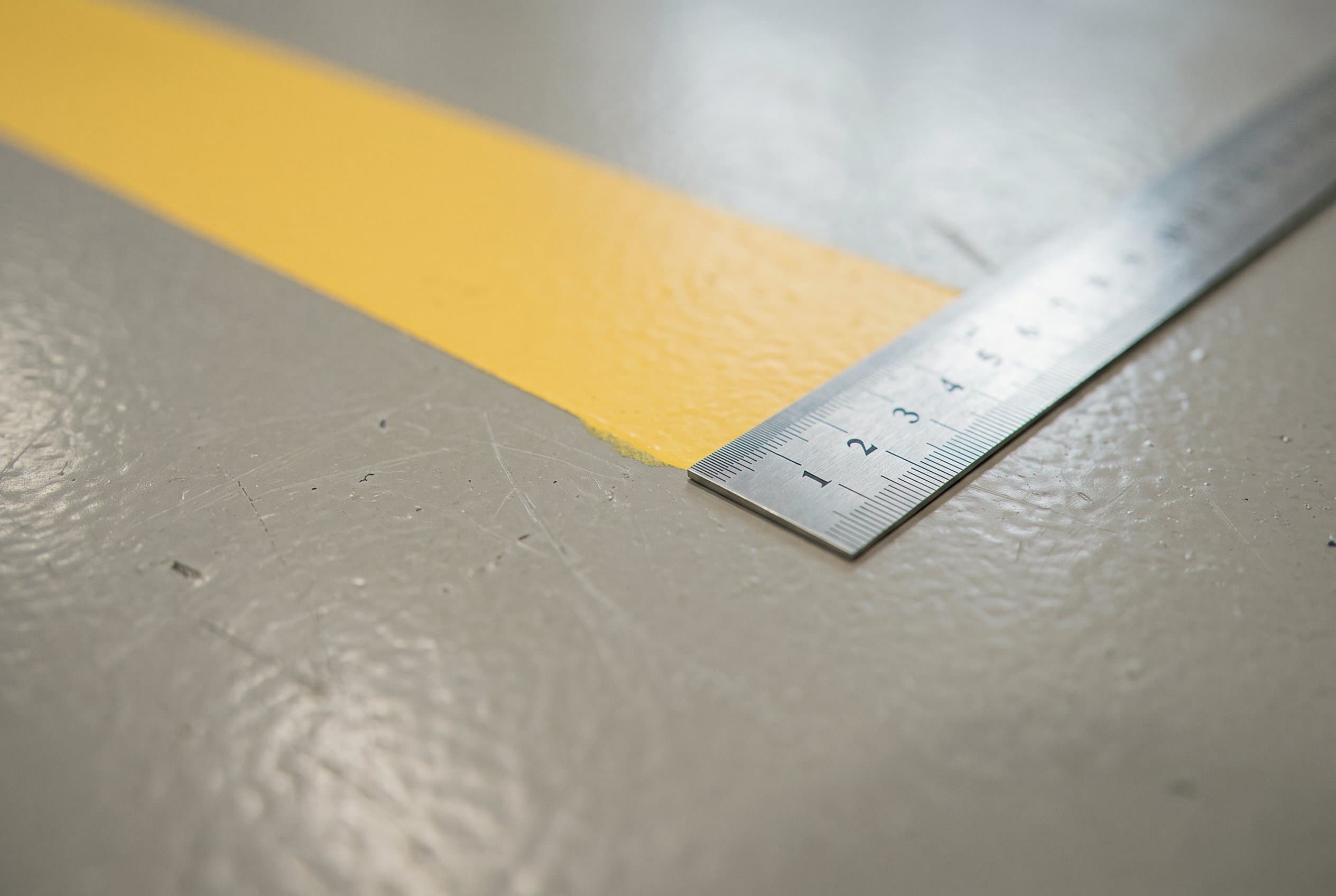 Epoxy floor edge along a warehouse wall.